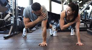Image of man and woman doing Cardio Crawley to tone their arms. 